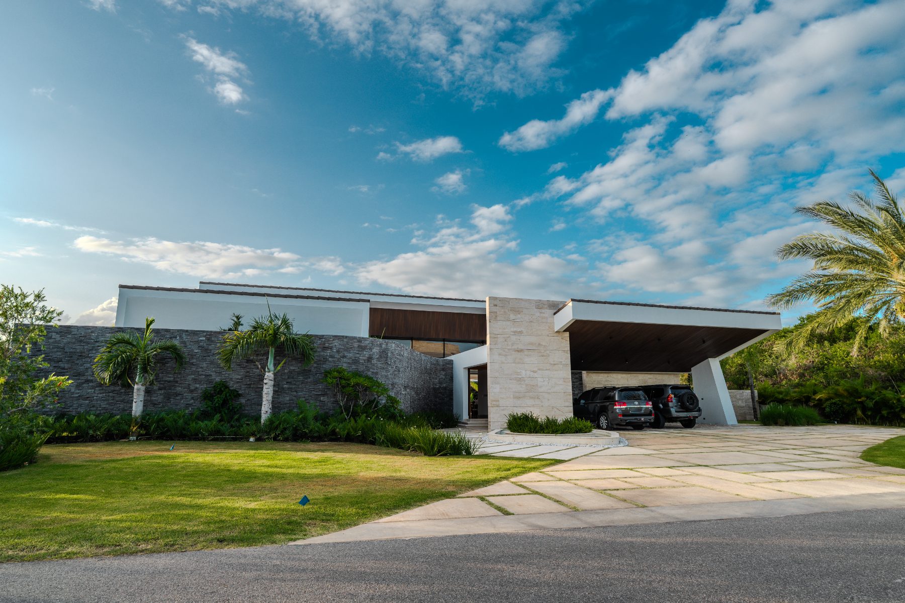 Villa street frontage with stone wall and carport