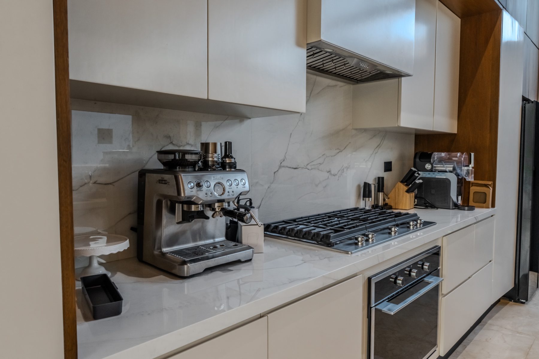 Kitchen run with marble splashback and gas hob